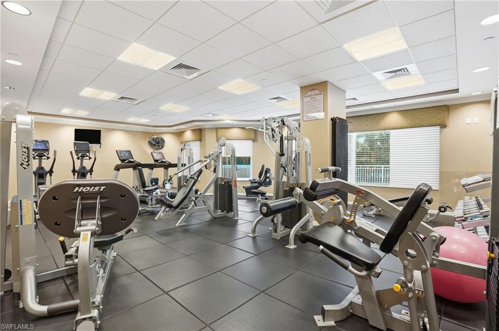 Workout area with a drop ceiling and recessed lighting - Virtually Edited Image