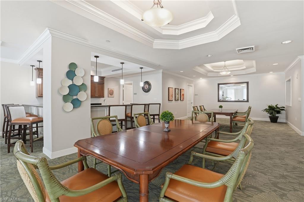Carpeted dining space in Community Room with a raised ceiling, ornamental molding, and recessed lighting - Virtually Edited Image