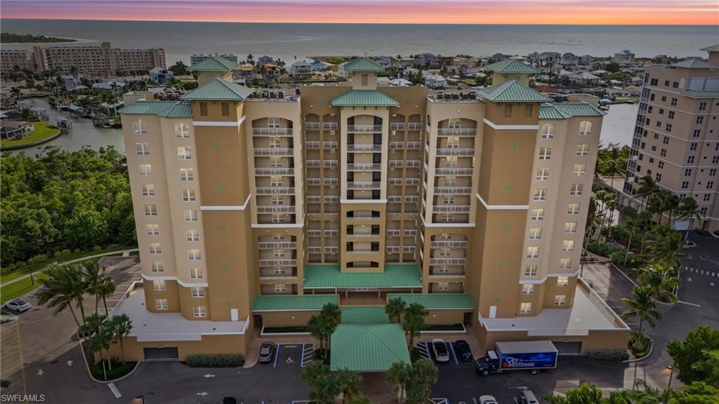 View of apartment building / complex featuring a water view - Virtually Edited Image