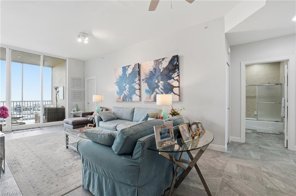 Living area with floor to ceiling windows and ceiling fan - Virtually Edited Image