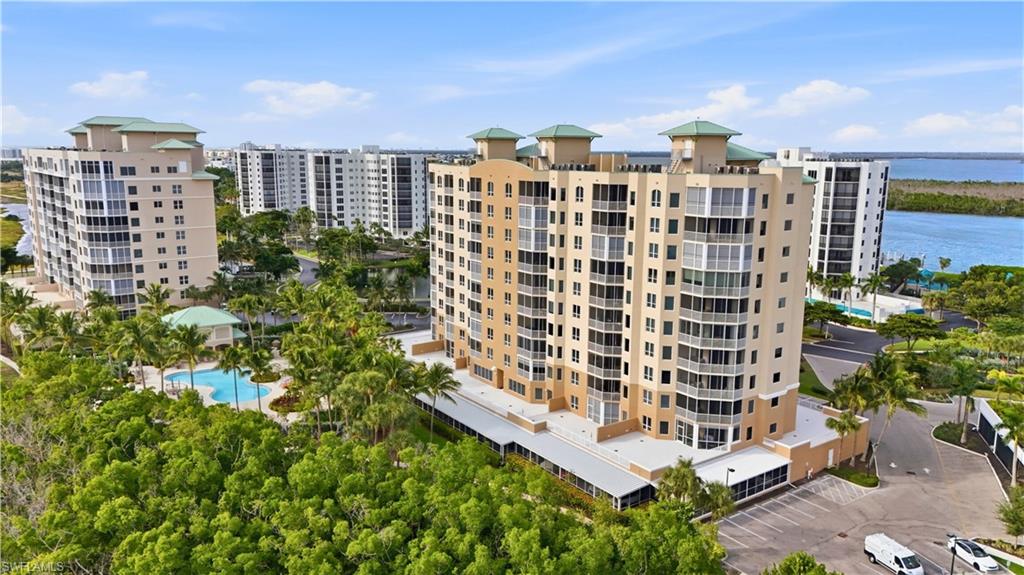 View of apartment building / complex featuring a water view - Virtually Edited Image