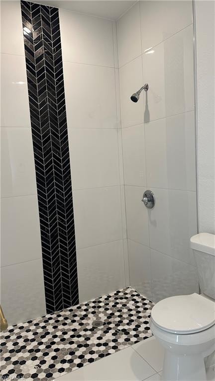 Bathroom with a stall shower and tile patterned flooring