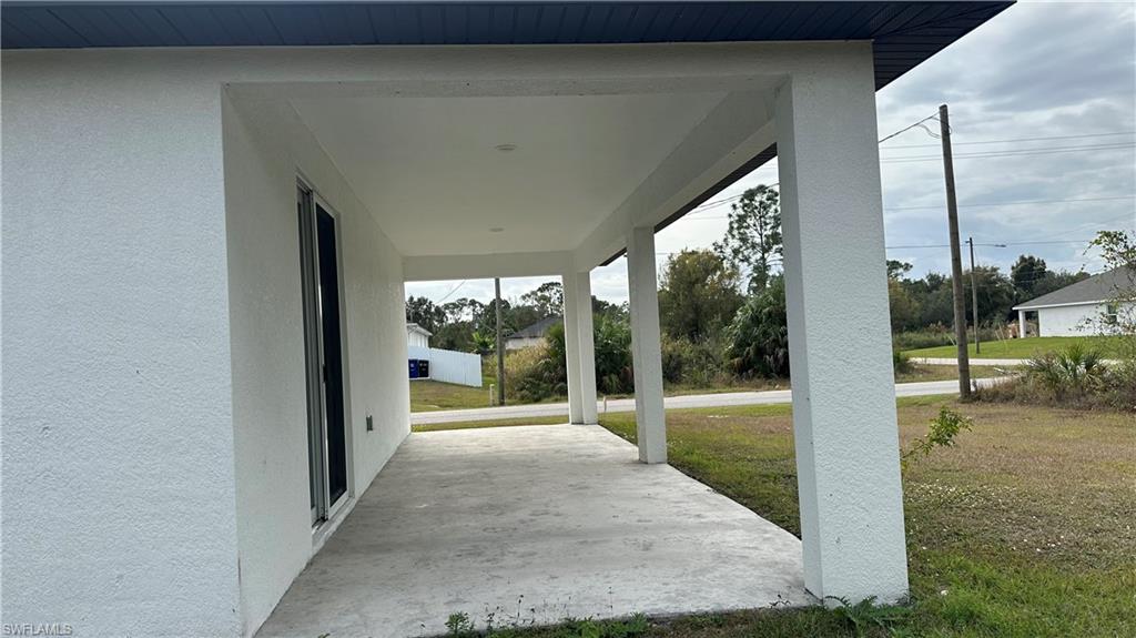 Porch featuring a lawn