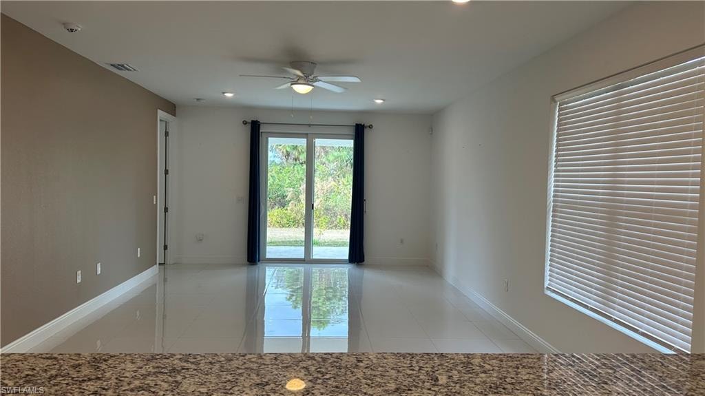 Unfurnished room featuring ceiling fan, light tile patterned flooring, and recessed lighting
