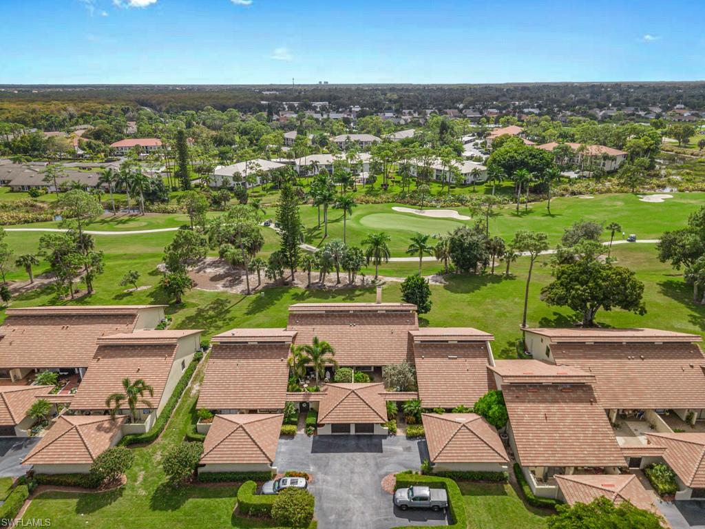 Aerial perspective of suburban area featuring a golf course