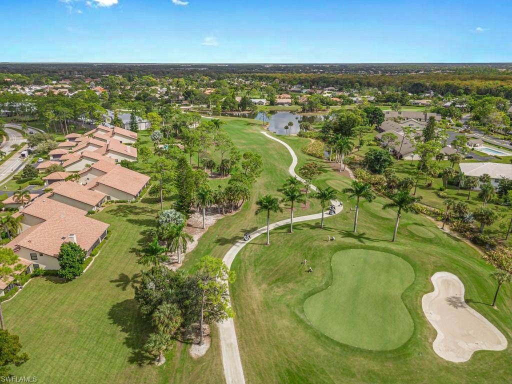 View of property location with nearby suburban area, a nearby body of water, and a golf club