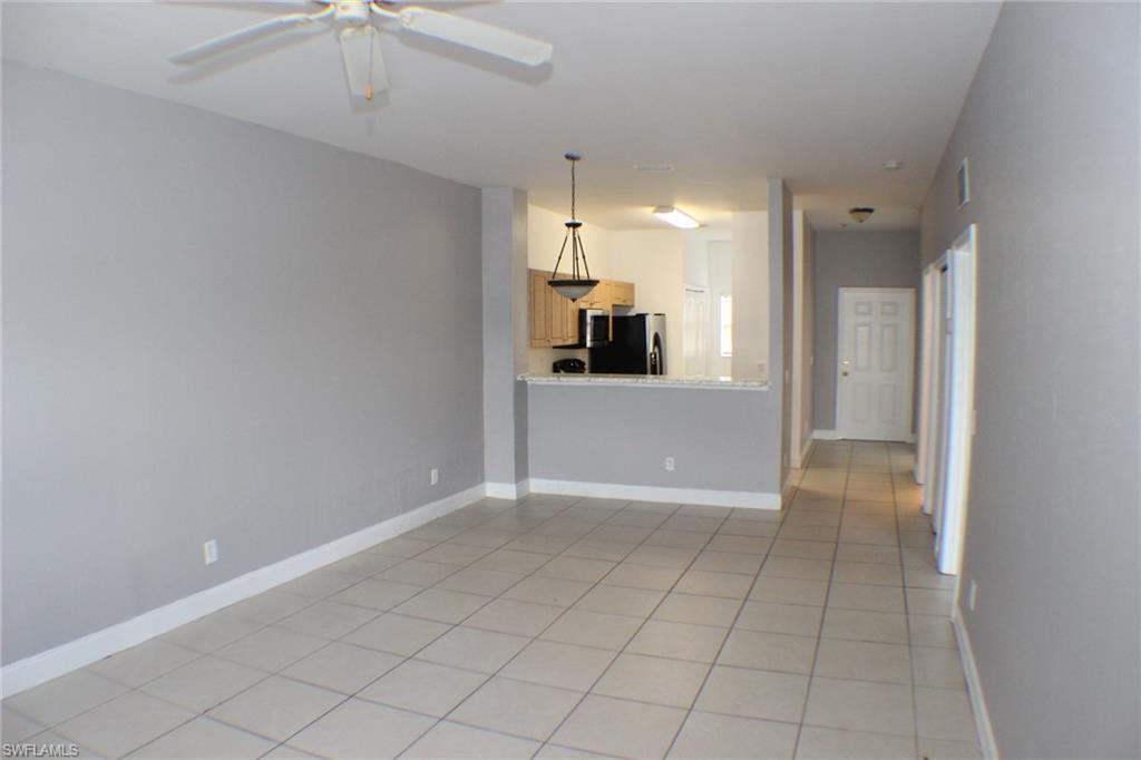 Spare room featuring light tile patterned floors and a ceiling fan