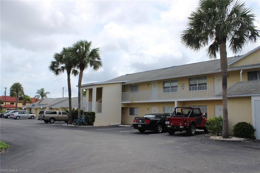 View of property featuring uncovered parking
