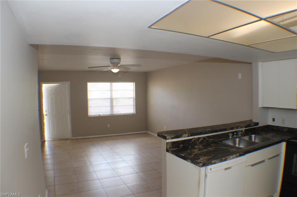 Kitchen with white cabinets, dishwasher, a ceiling fan, black / electric stove, and open floor plan