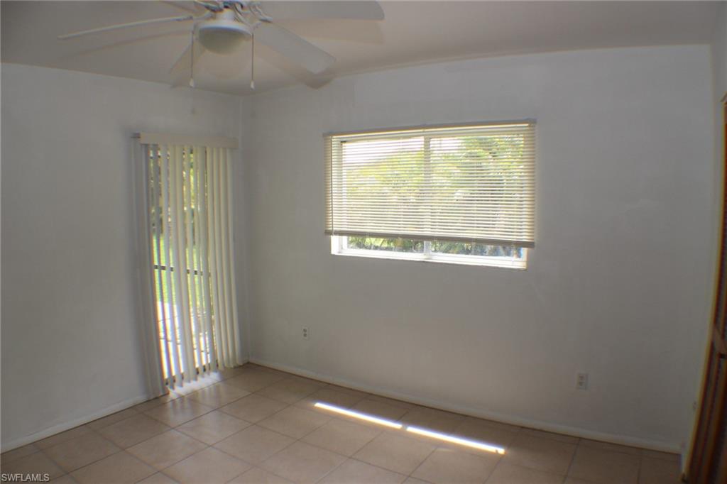 Unfurnished room with ceiling fan and light tile patterned flooring