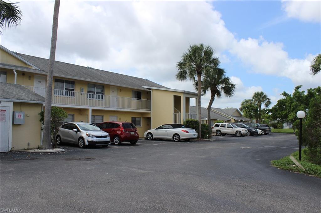 View of building exterior with uncovered parking