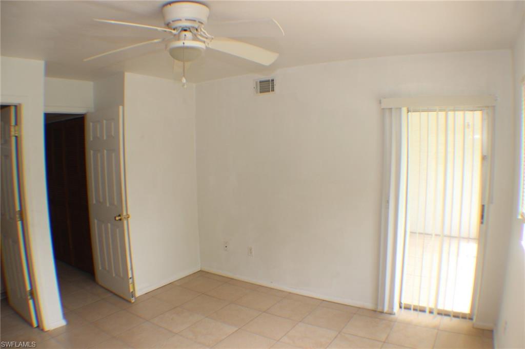 Spare room featuring a ceiling fan and light tile patterned floors