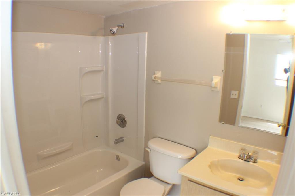 Bathroom with vanity and tub / shower combination
