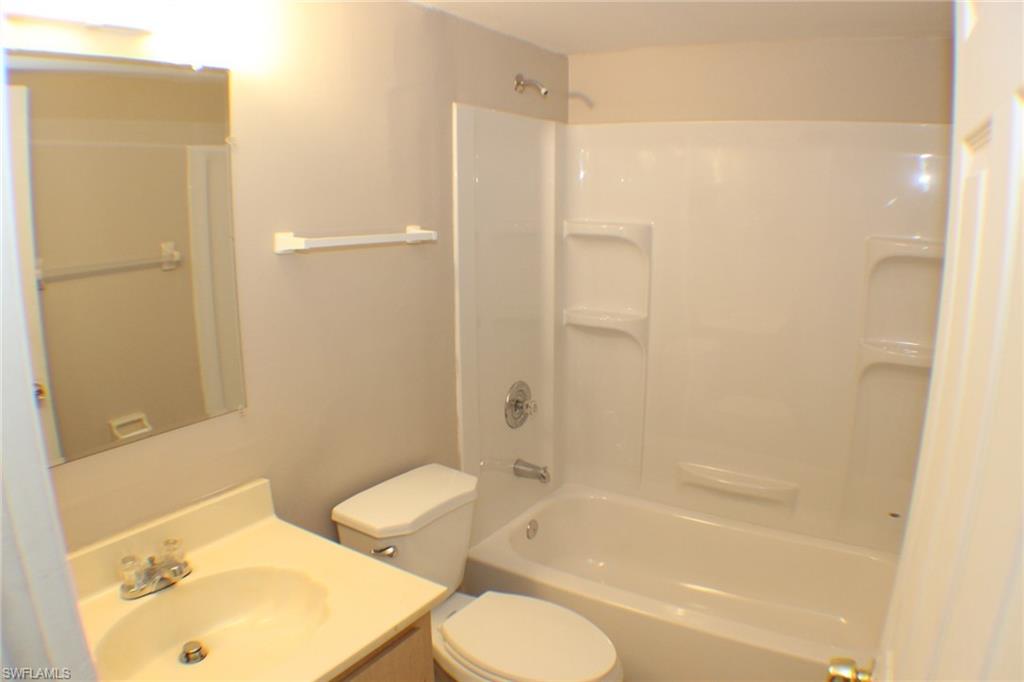 Bathroom with vanity and bathing tub / shower combination