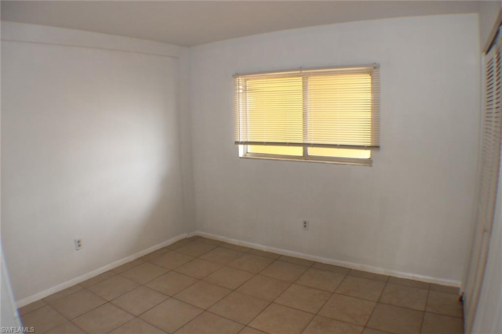 Spare room with baseboards and light tile patterned floors