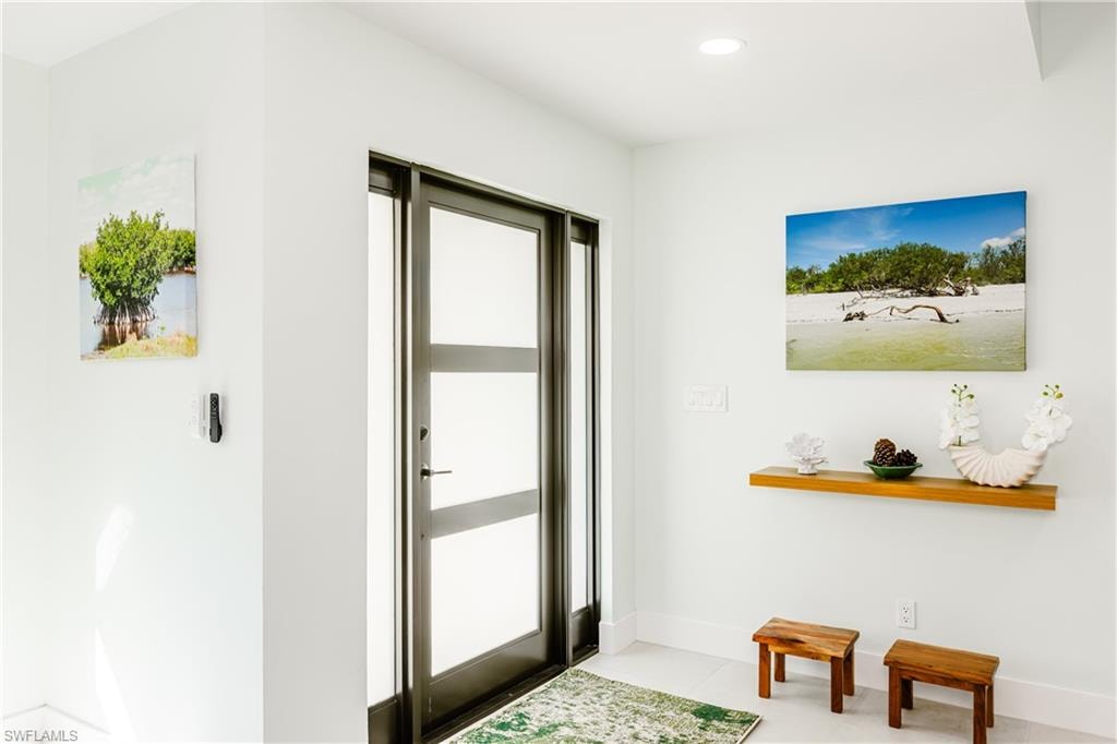 Doorway featuring recessed lighting and tile patterned floors