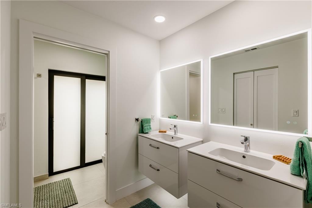 Bathroom with dual suspended vanities