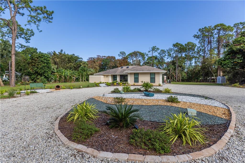 View of front of house with large circular driveway