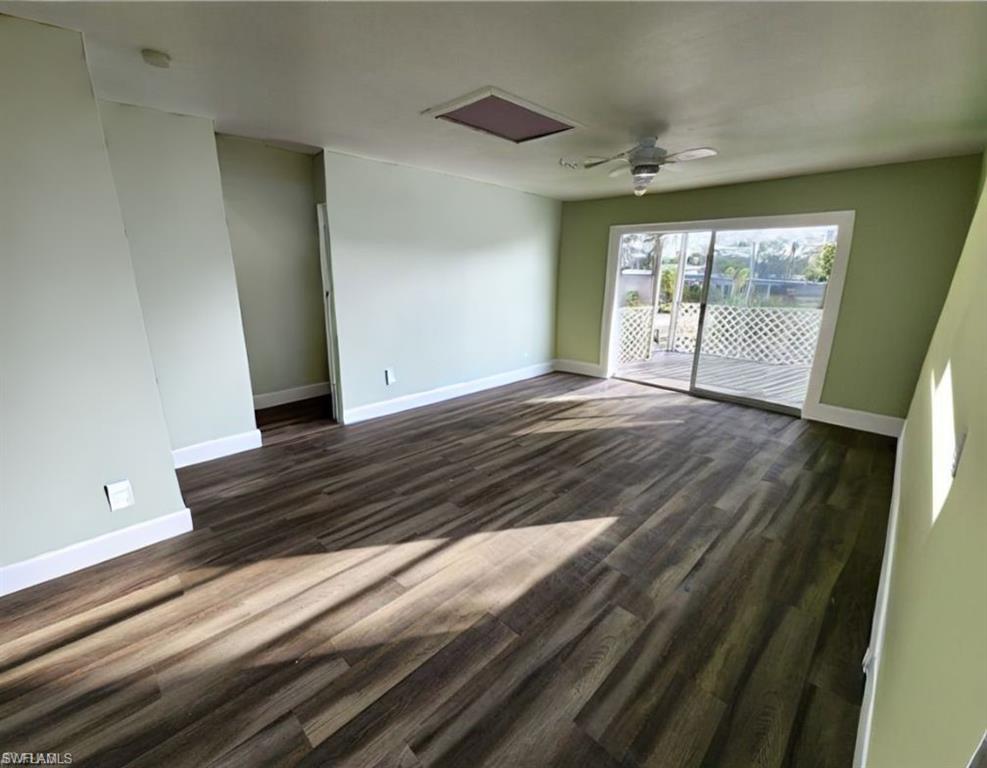 Living room featuring ceiling fan and dark wood-type flooring VIRTUALLY EDITED