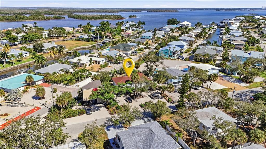 Aerial perspective of suburban area with a nearby body of water - Virtually Edited Image