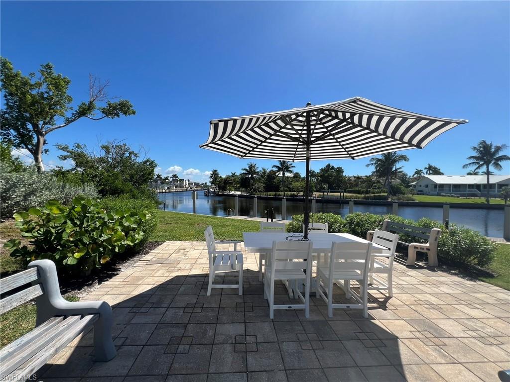 View of patio / terrace featuring a water view and outdoor dining area