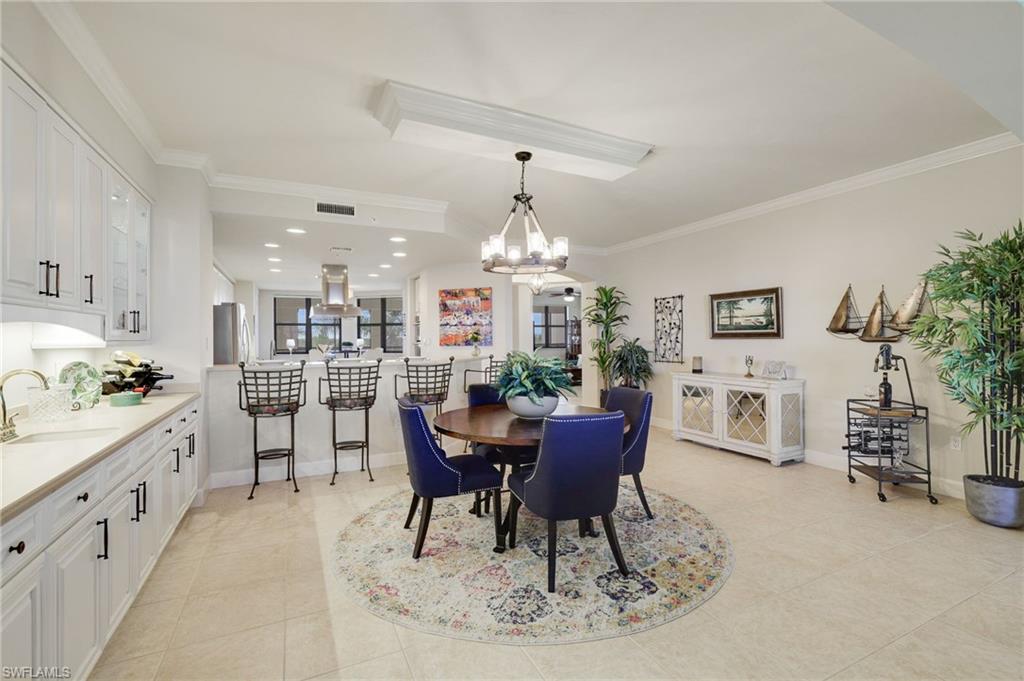Built In wet bar featuring 42" glass  cabinets with accent lighting and under counter storage.