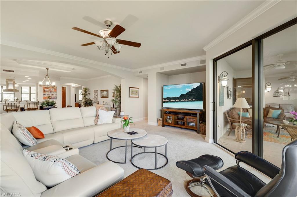 Dining room with crown molding and chandelier, built in wet bar with storage.