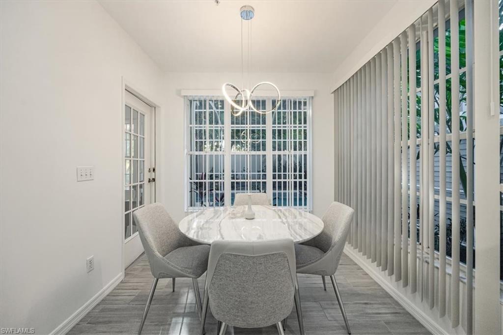 Dining space with wood tiled floors and a chandelier