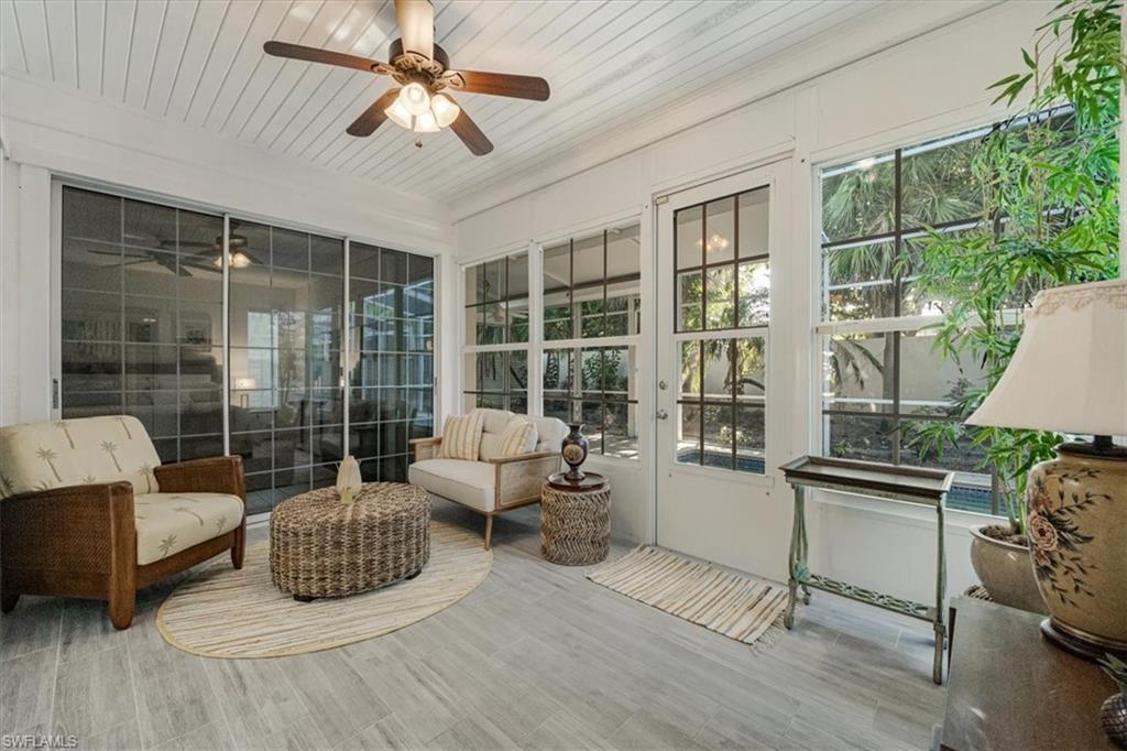 Sunroom featuring french doors and wood finished floors