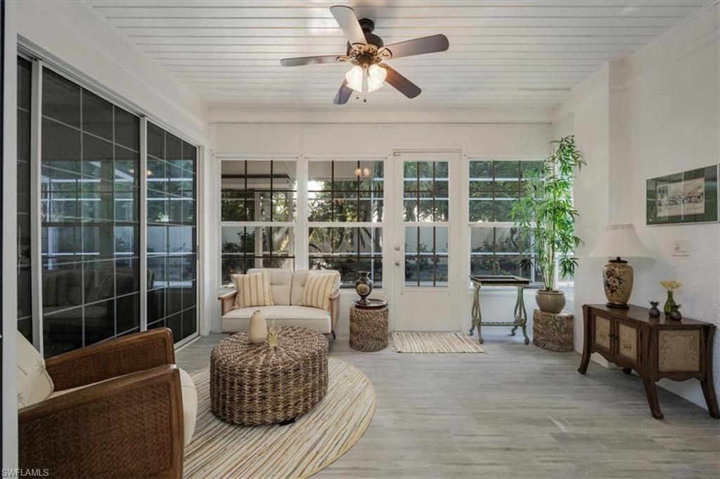 Sunroom featuring wooden ceiling and wood finished floors