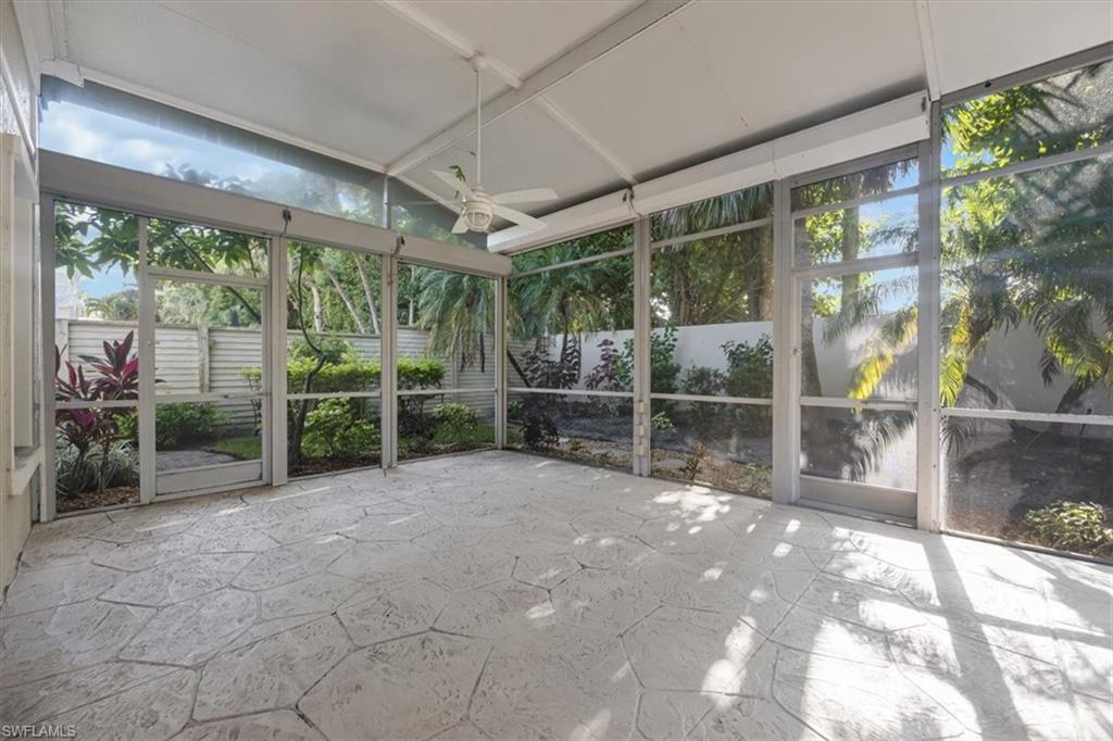 Unfurnished sunroom featuring ceiling fan and plenty of natural light