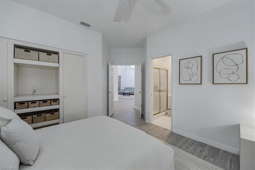 Bedroom featuring light wood-style floors, ceiling fan, and a closet