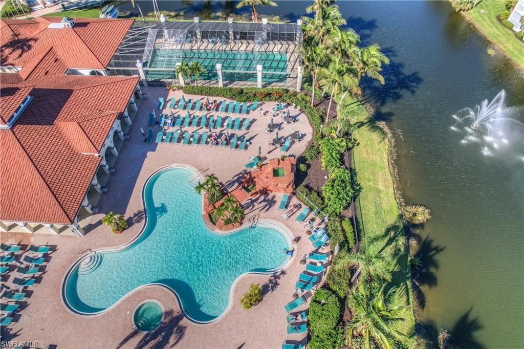 Aerial view of a pool area and a nearby body of water