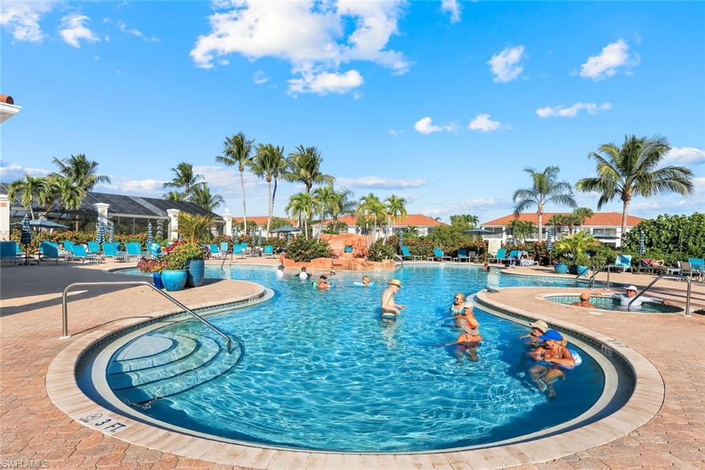 Community pool featuring a patio area and a hot tub