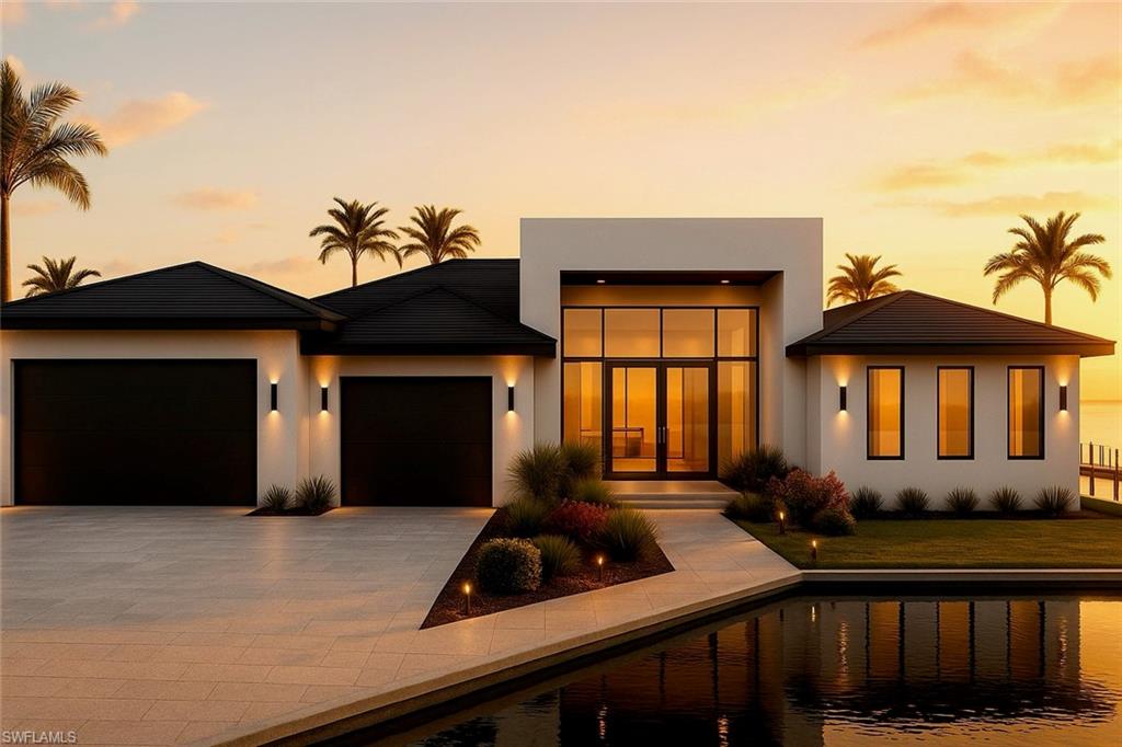 View of front of home featuring an attached garage, driveway, and stucco siding