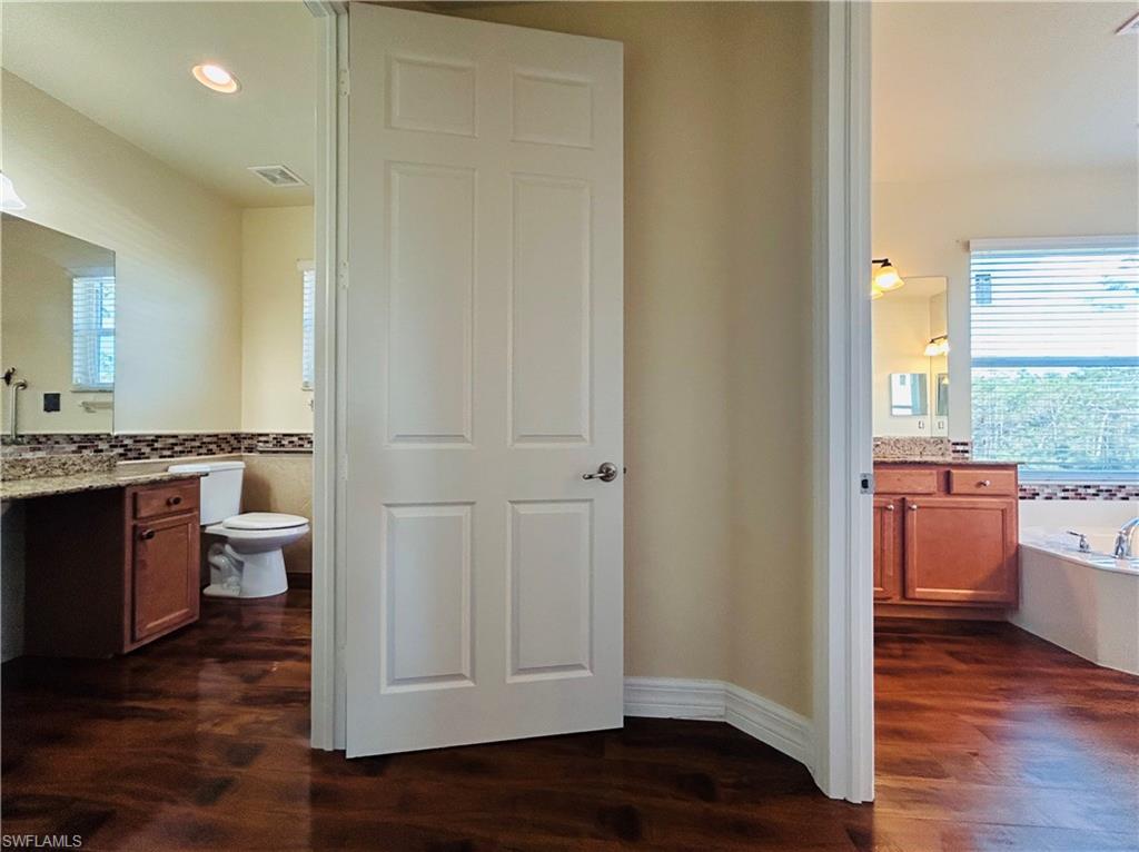 This a master bedroom with separate rooms / sinks to get ready.