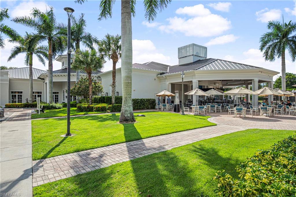 View of property's community with a lawn and a patio