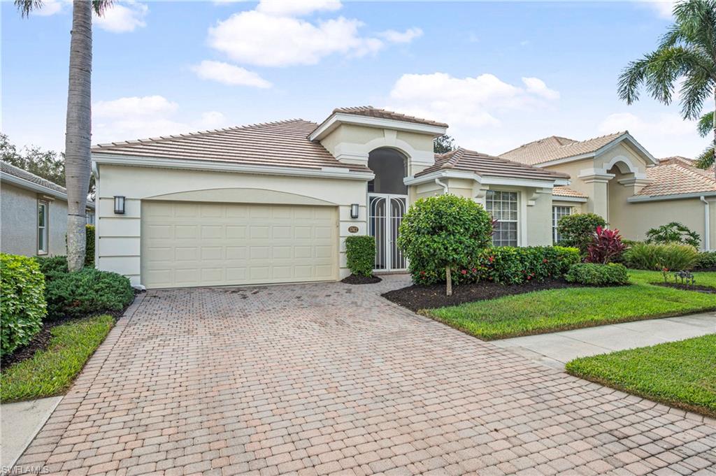Mediterranean / spanish home with stucco siding, decorative driveway, a garage, and a tiled roof