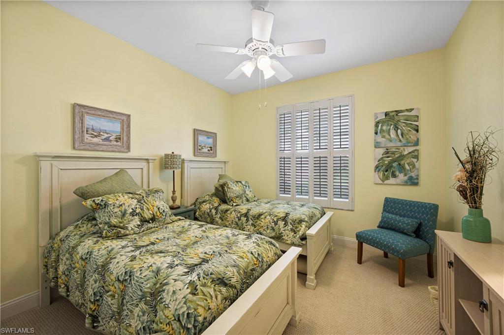 Bedroom featuring light colored carpet and a ceiling fan