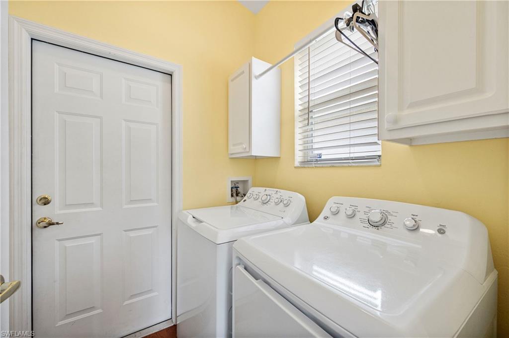 Washroom with cabinet space and washer and dryer