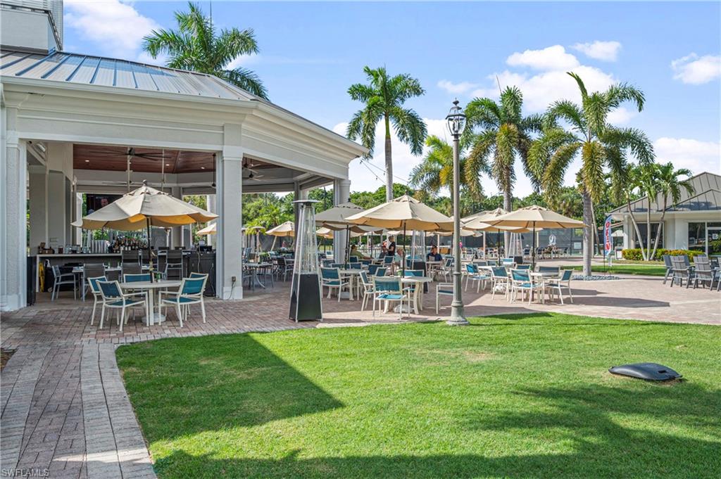Surrounding community with a lawn and a patio area