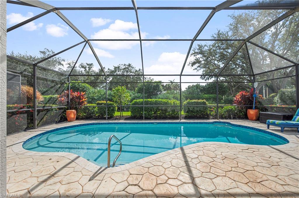 Outdoor pool featuring a sunroom, a lanai, and a patio area