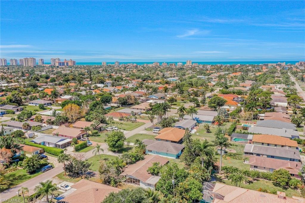 Aerial perspective of suburban area with a nearby body of water