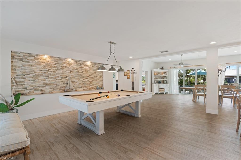 Recreation room featuring ceiling fan, billiards, and light wood look tile floors