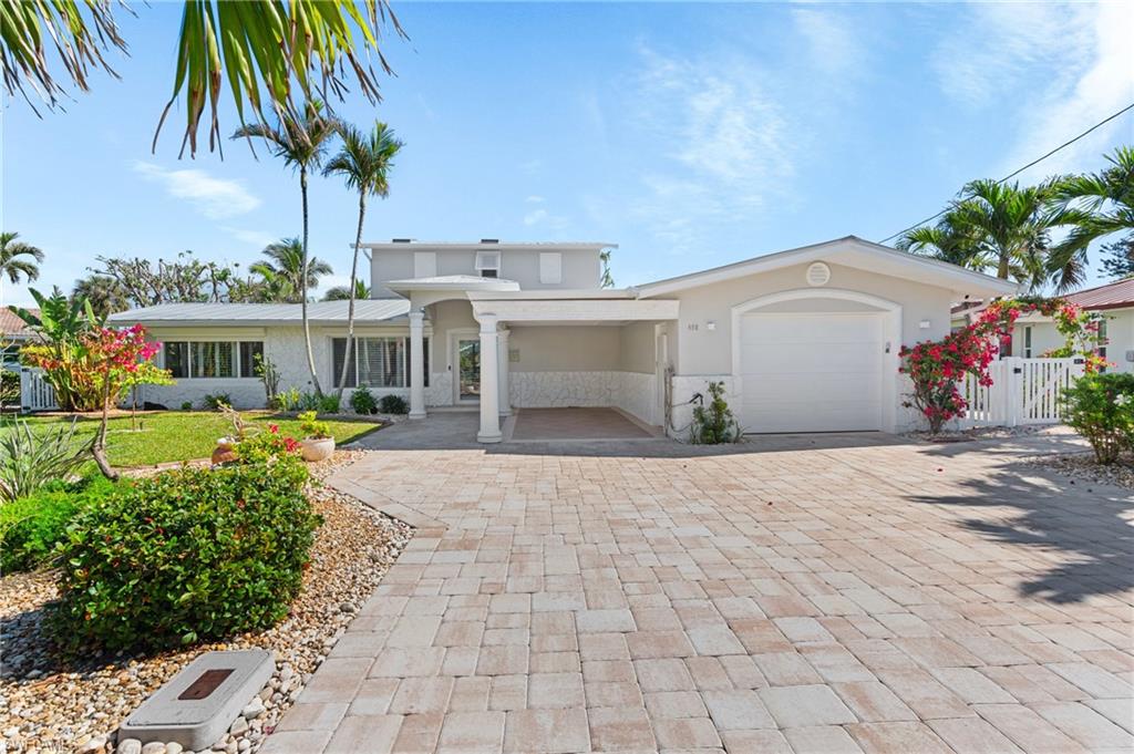 View of front of house with a garage -Virtually enhanced image