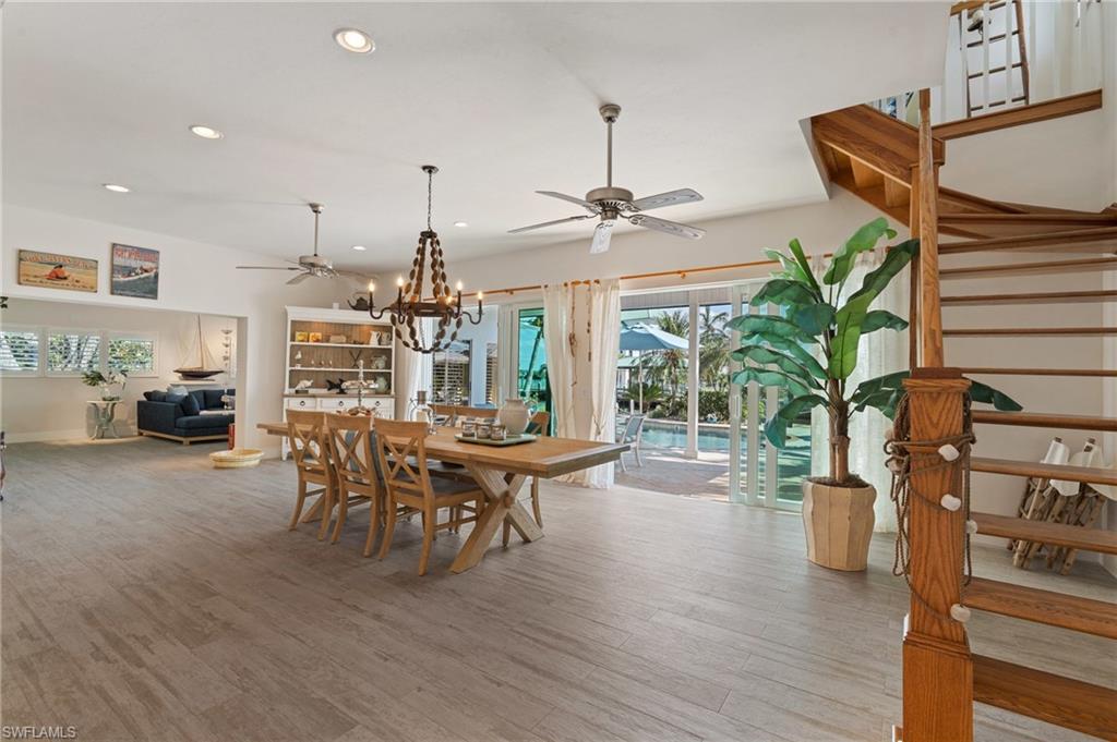 Dining space with wood look tile floors and ceiling fan