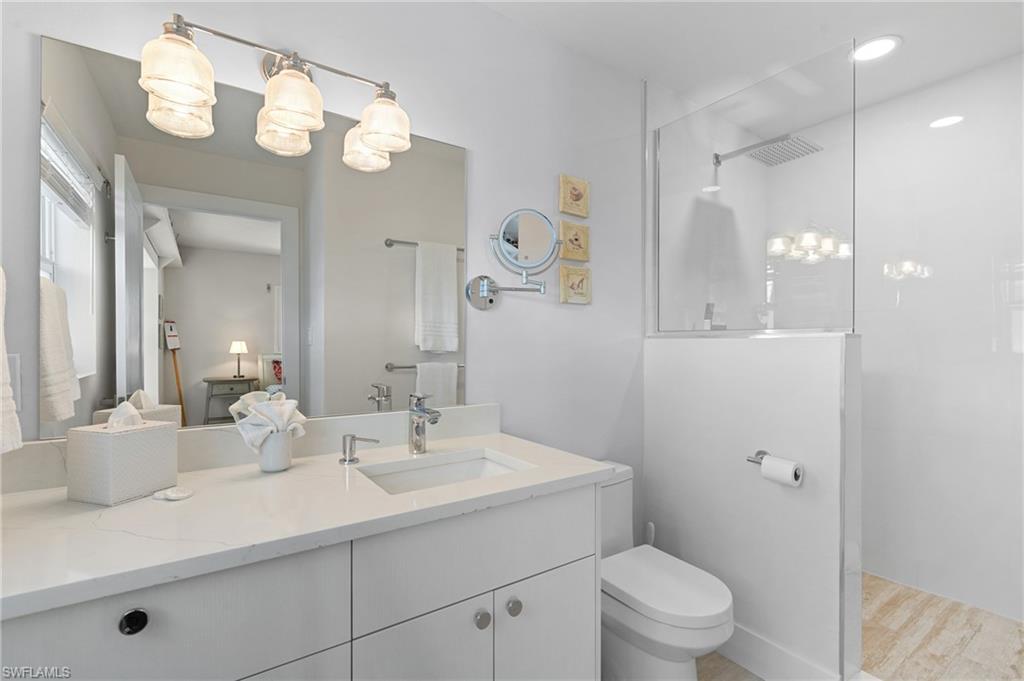 Bathroom with vanity, toilet, and walk in shower