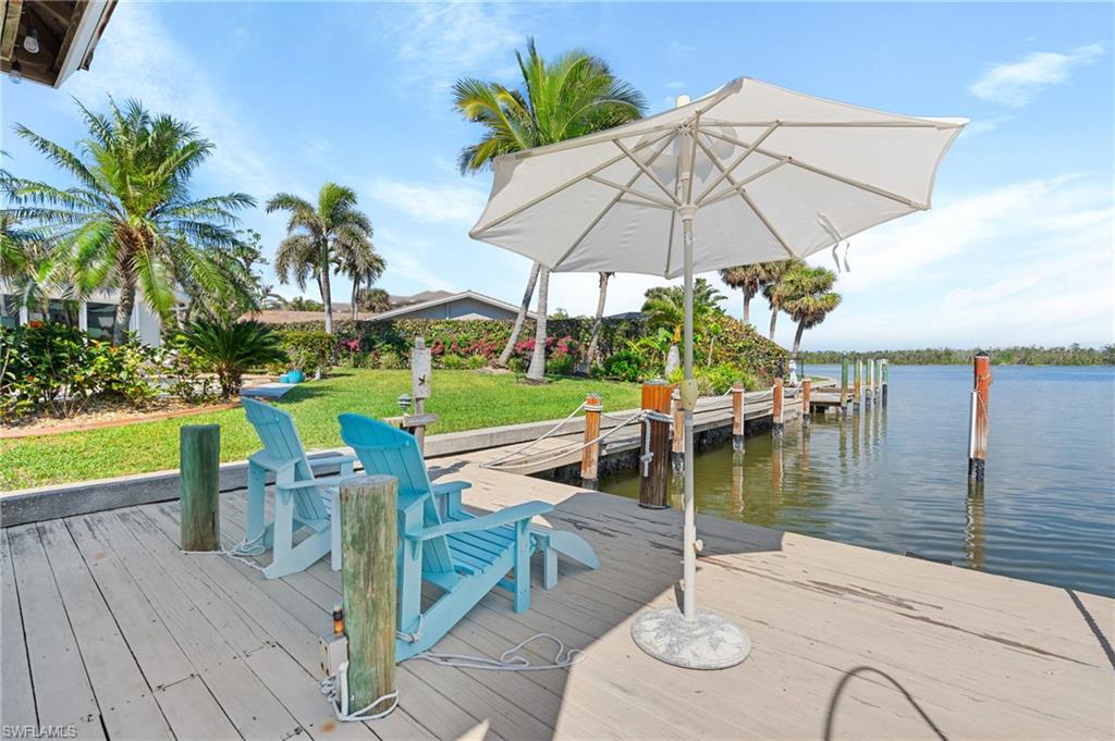 Dock area with a water view and a lawn Virtually enhanced image