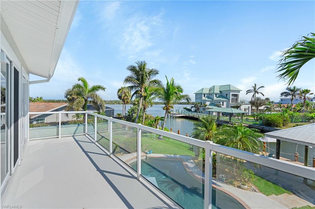 Balcony featuring a water view -Virtually enhanced image