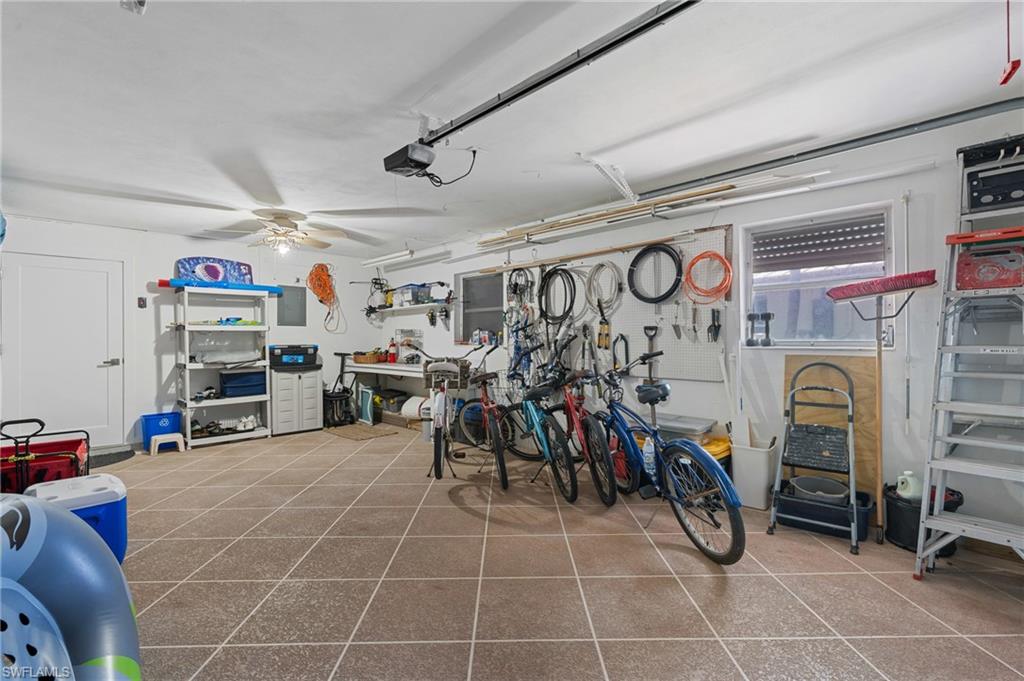 Garage featuring a garage door opener and ceiling fan